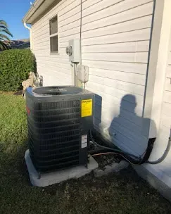 Family enjoying a comfortable indoor environment with a modern air conditioning unit, highlighting the benefits of efficient AC maintenance